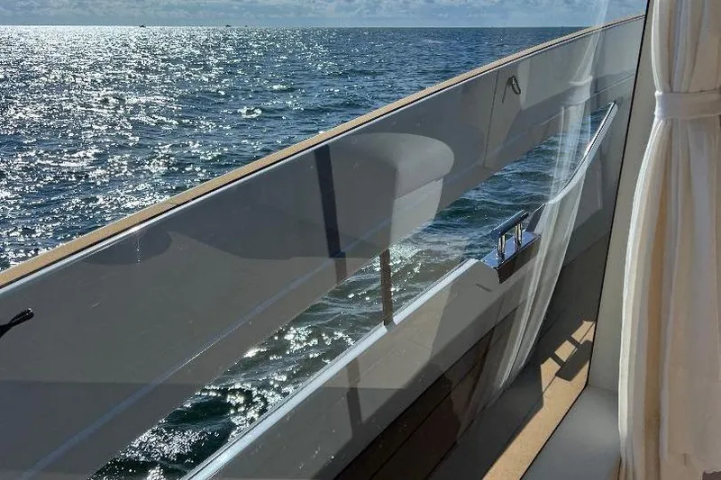 Slide: The Image of Azimut SeaDeck6 2025 yacht with ocean view and elegant glass railing. - 8