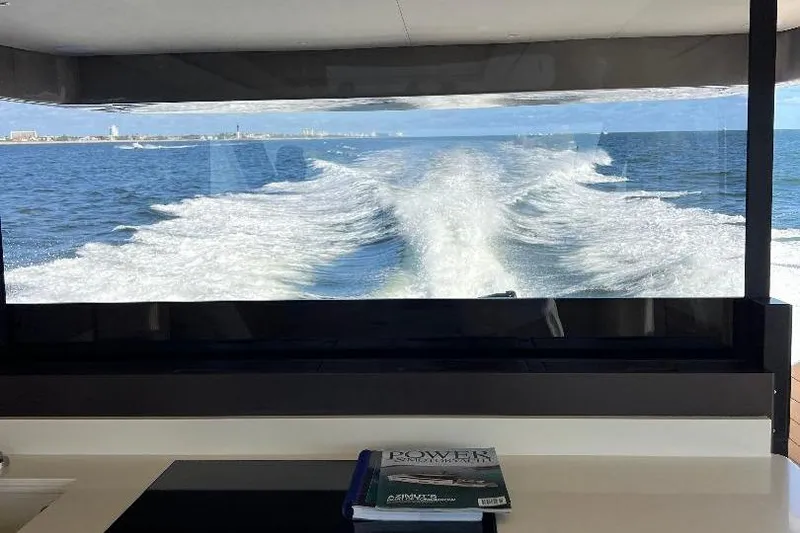 Slide: The Image of 2025 Azimut SeaDeck6 yacht interior with ocean view and wake trail. - 9