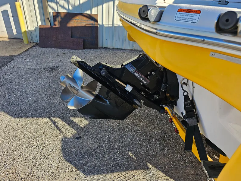 Slide: The Image of Yellow 2011 Tahoe 225 boat with MerCruiser outboard motor and stainless steel propeller. - 3