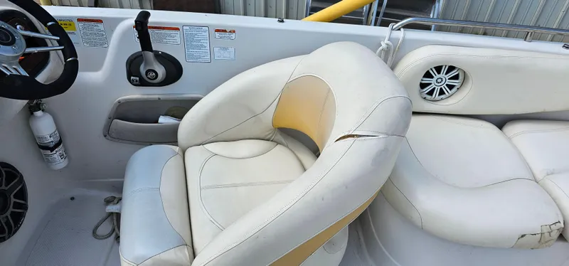 Slide: The Image of Interior of a 2011 Tahoe 225 boat with white leather seating and steering wheel. - 6