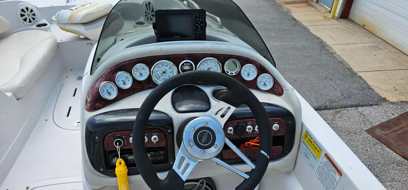 Slide: The Image of 2011 Tahoe 225 boat dashboard with steering wheel and gauges. - 7