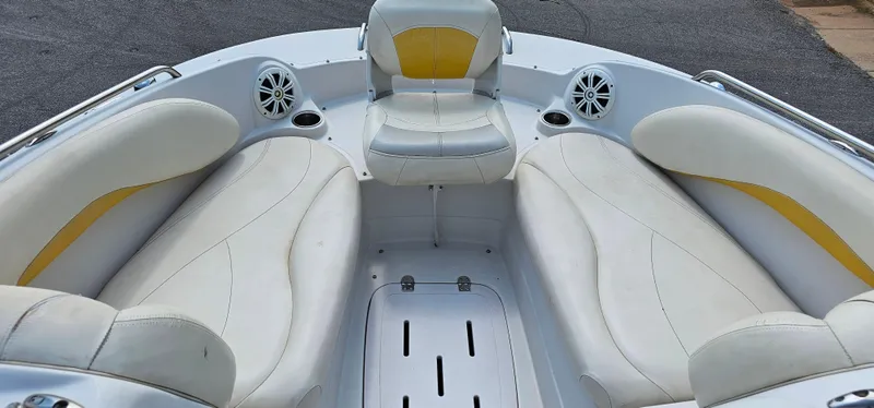 Slide: The Image of 2011 Tahoe 225 boat interior with white and yellow seating, cup holders, and speakers. - 9