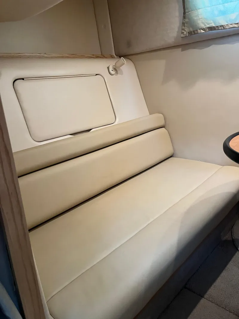 Slide: The Image of 2003 Maxum 3300 SCR interior with beige seating and compact design. - 10