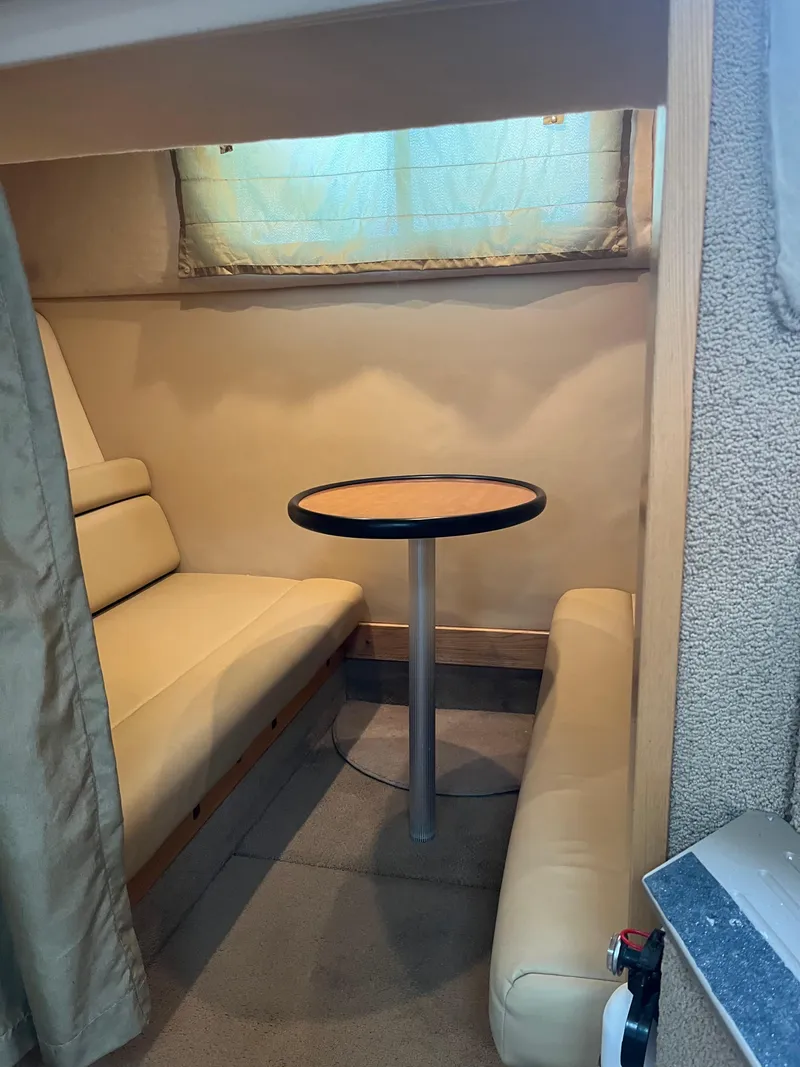 Slide: The Image of 2003 Maxum 3300 SCR cabin interior with seating and table. - 11