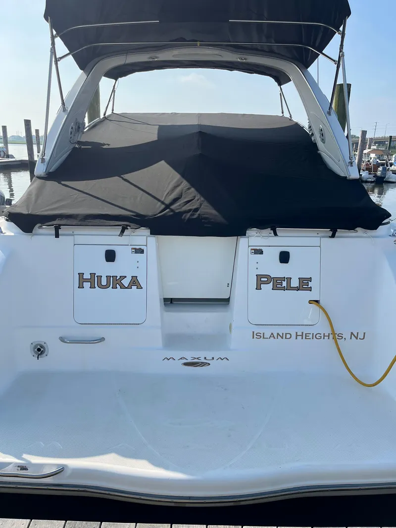 Slide: The Image of 2003 Maxum 3300 SCR boat docked, featuring "Huka Pele" and Island Heights, NJ text. - 4