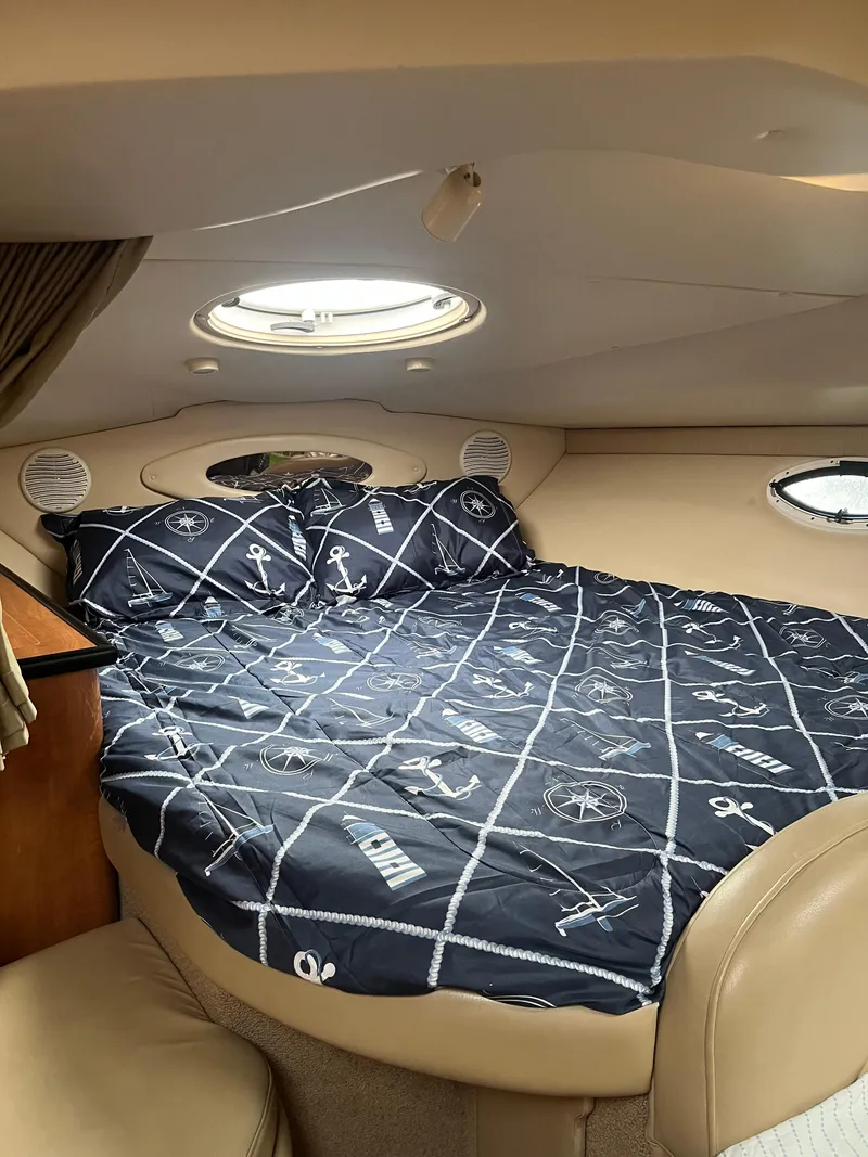 Slide: The Image of Cozy cabin interior of 2003 Maxum 3300 SCR with nautical-themed bedding. - 7
