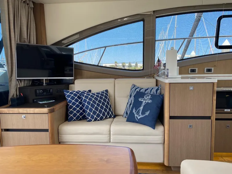 Slide: The Image of Interior of 2018 Sea Ray 400 Fly yacht with cozy seating and nautical decor. - 12