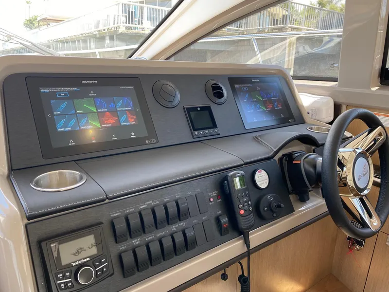 Slide: The Image of Helm of 2018 Sea Ray 400 Fly yacht with modern navigation displays and controls. - 16