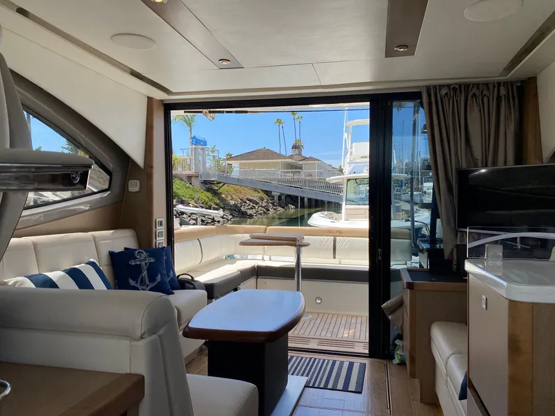 Slide: The Image of Luxurious interior of 2018 Sea Ray 400 Fly yacht with elegant seating and marina view. - 19