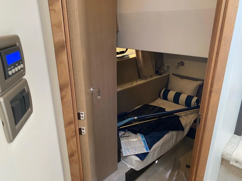 Slide: The Image of Cabin interior of 2018 Sea Ray 400 Fly yacht with cozy bed and striped pillows. - 30