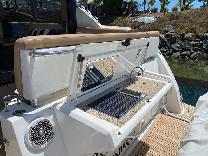 Slide: The Image of 2018 Sea Ray 400 Fly yacht with open storage compartment on deck. - 4