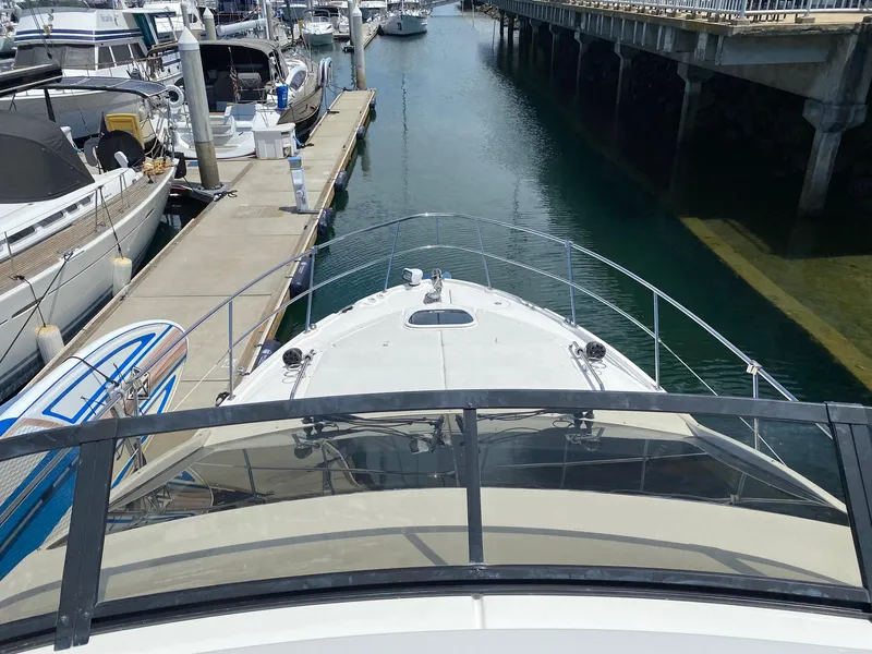 Slide: The Image of 2018 Sea Ray 400 Fly yacht docked at marina, view from flybridge. - 42