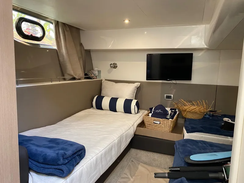 Slide: The Image of Cozy cabin interior of 2018 Sea Ray 400 Fly yacht with bed, TV, and decor. - 44