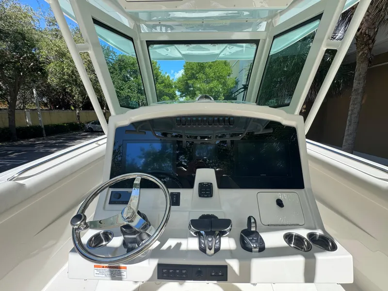 Slide: The Image of 2026 Sailfish 312 CC boat cockpit with steering wheel and control panel. - 16
