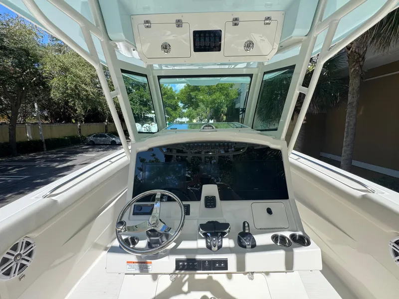Slide: The Image of 2026 Sailfish 312 CC boat cockpit with steering wheel and control panel. - 17