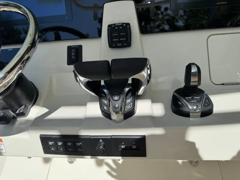 Slide: The Image of Control panel of 2026 Sailfish 312 CC boat with steering wheel and throttle controls. - 19
