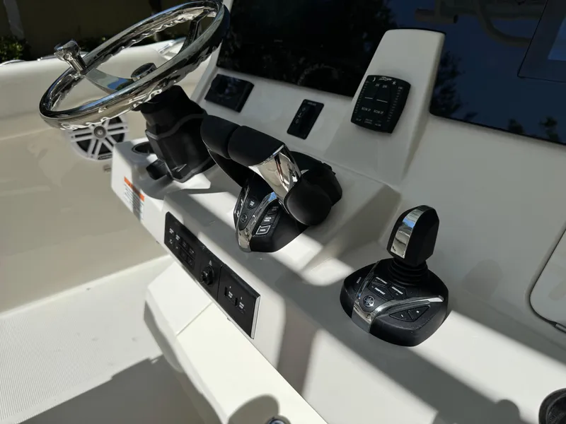 Slide: The Image of 2026 Sailfish 312 CC boat helm with steering wheel and control panel. - 20