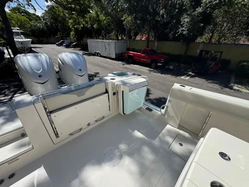 Slide: The Image of 2026 Sailfish 312 CC boat with dual engines, parked outdoors in a sunny setting. - 25