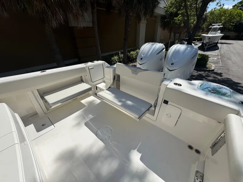 Slide: The Image of 2026 Sailfish 312 CC boat interior with foldable seating and twin outboard engines. - 28
