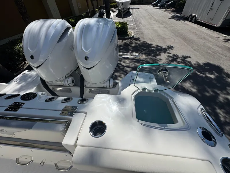Slide: The Image of 2026 Sailfish 312 CC boat with dual outboard engines and open storage compartment. - 32