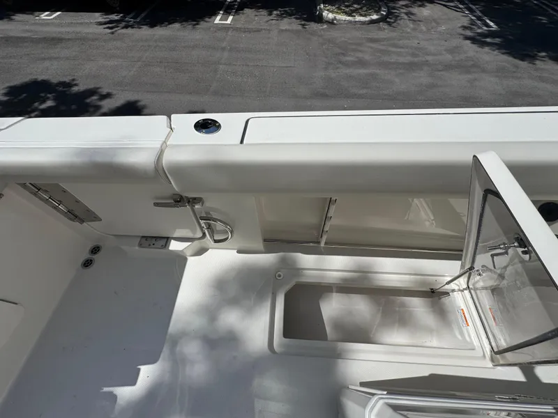 Slide: The Image of 2026 Sailfish 312 CC boat deck with open storage compartment, showcasing sleek design. - 33