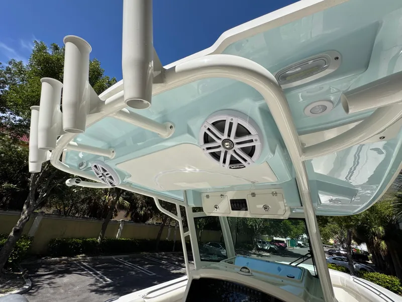 Slide: The Image of 2026 Sailfish 312 CC boat with speakers and rod holders under a clear blue sky. - 34