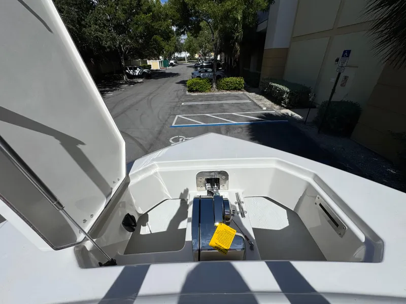 Slide: The Image of Open anchor compartment of 2026 Sailfish 312 CC boat in a parking lot. - 7