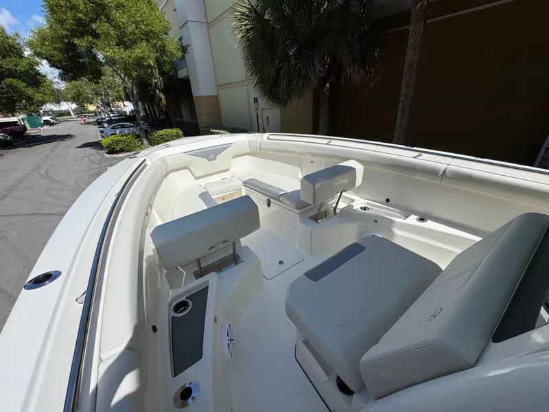 Slide: The Image of 2026 Sailfish 312 CC boat interior with white seating and cup holders. - 9