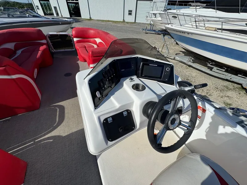 Slide: The Image of Aloha Tropical Series 230 boat interior with red seating and modern dashboard, 2020 model. - 6
