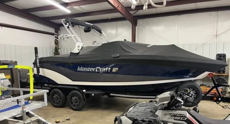 Slide: The Image of 2018 MasterCraft XT21 boat with cover in a garage setting. - 3