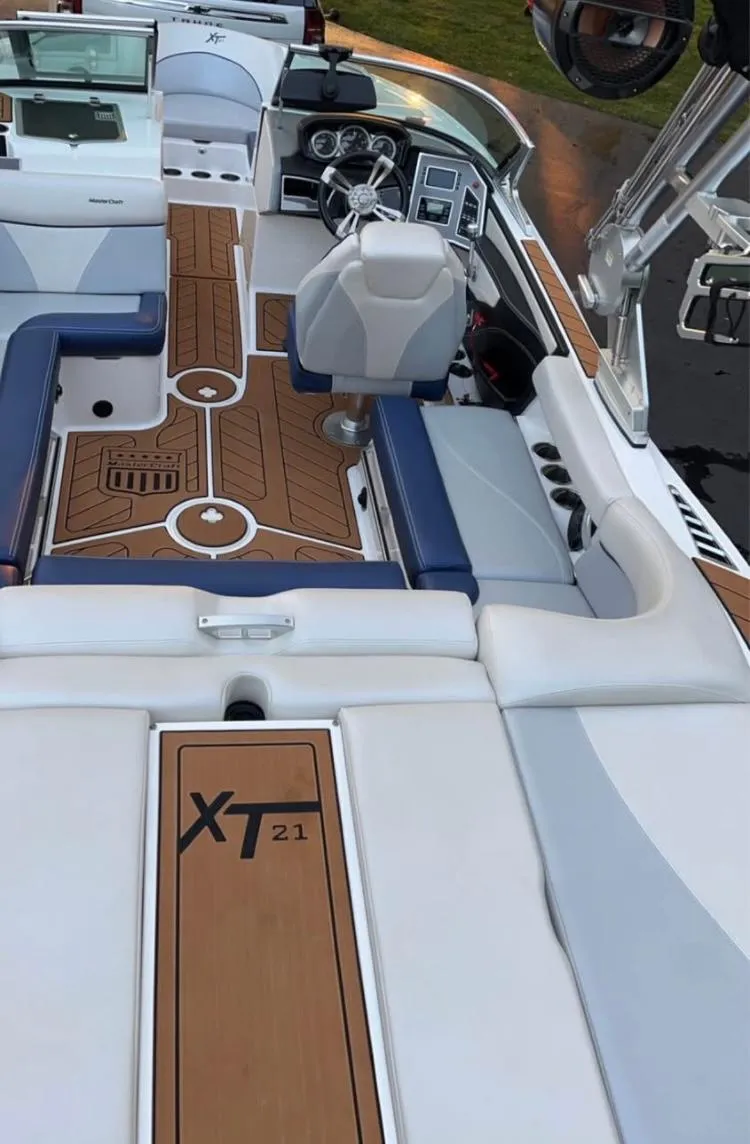 Slide: The Image of 2018 MasterCraft XT21 boat interior with modern dashboard and seating. - 7