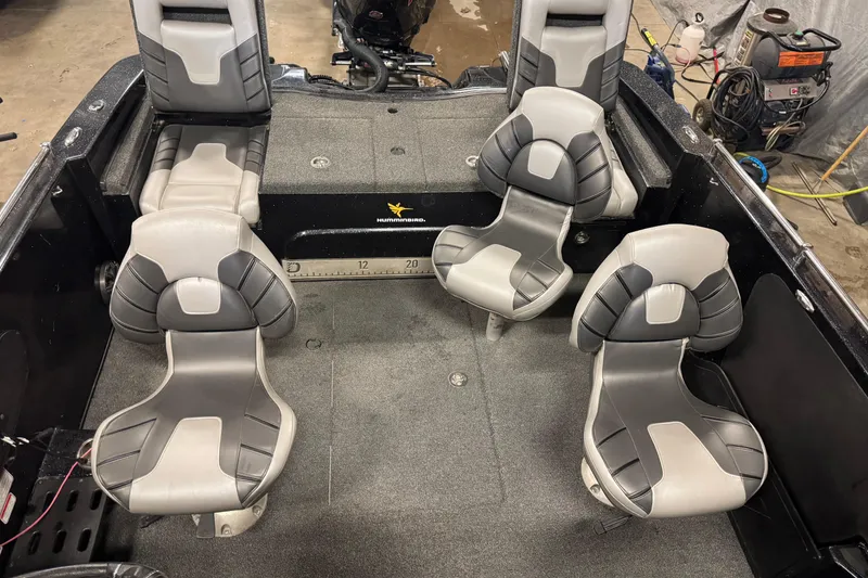 Slide: The Image of 2020 Nitro ZV19 Sport boat interior with four gray seats and measuring ruler. - 20