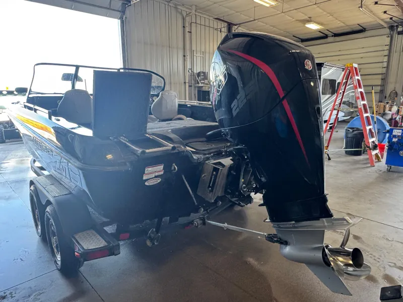 Slide: The Image of 2020 Nitro ZV19 Sport boat in a garage, featuring a powerful outboard motor. - 4