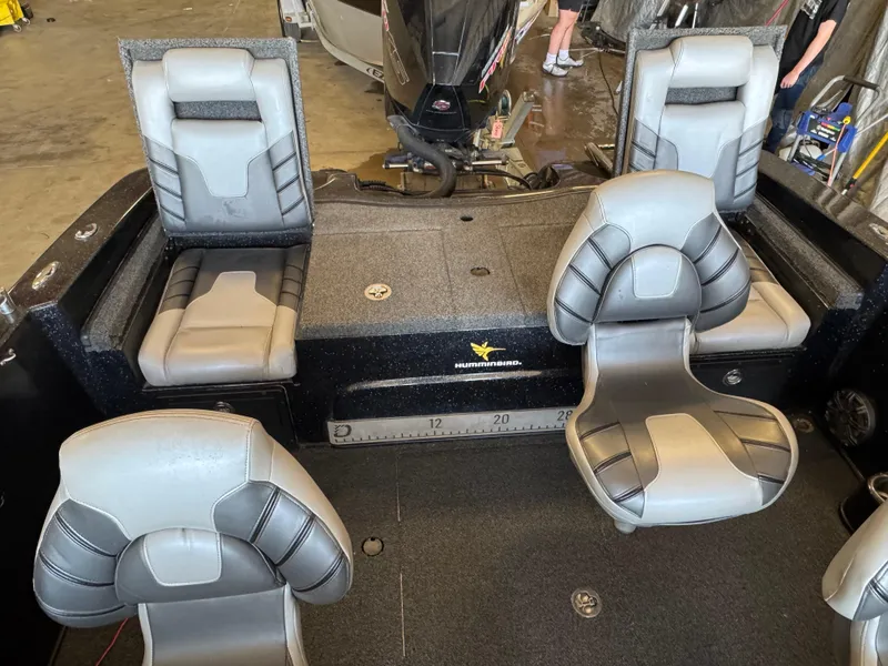 Slide: The Image of 2020 Nitro ZV19 Sport boat interior with gray seats and motor. - 9