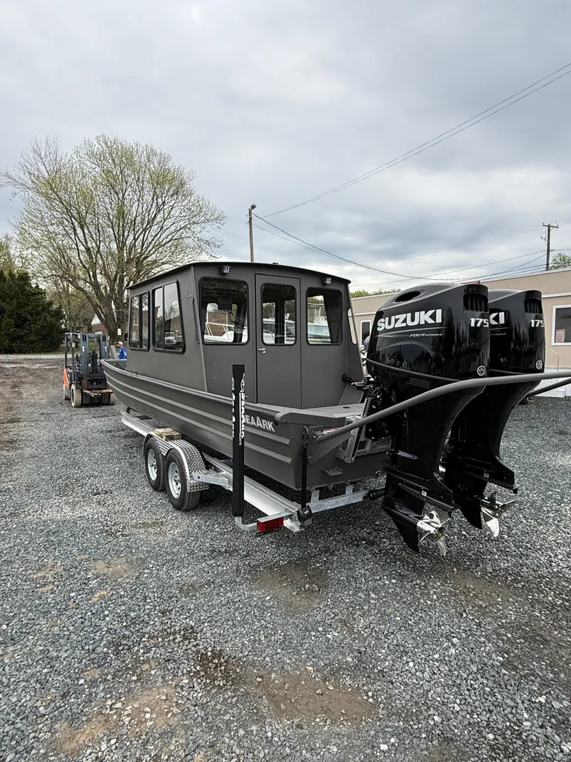 Slide: The Image of 2025 SeaArk 2672 Workhorse boat with Suzuki 175 outboard motor on a trailer. - 2
