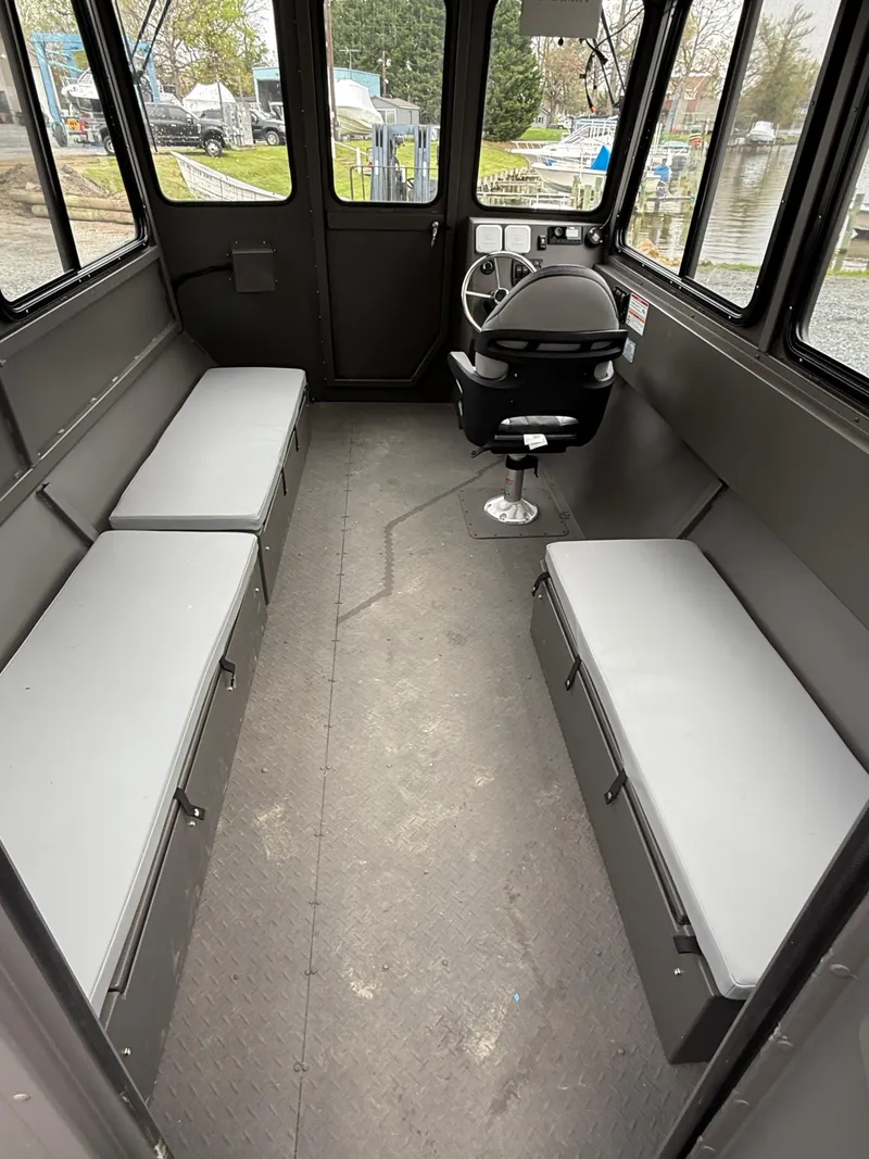 Slide: The Image of Interior of 2025 SeaArk 2672 Workhorse boat with seating and steering console. - 6