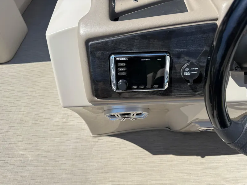 Slide: The Image of 2017 Bennington G22 dashboard with Kicker media center and audio input. - 11