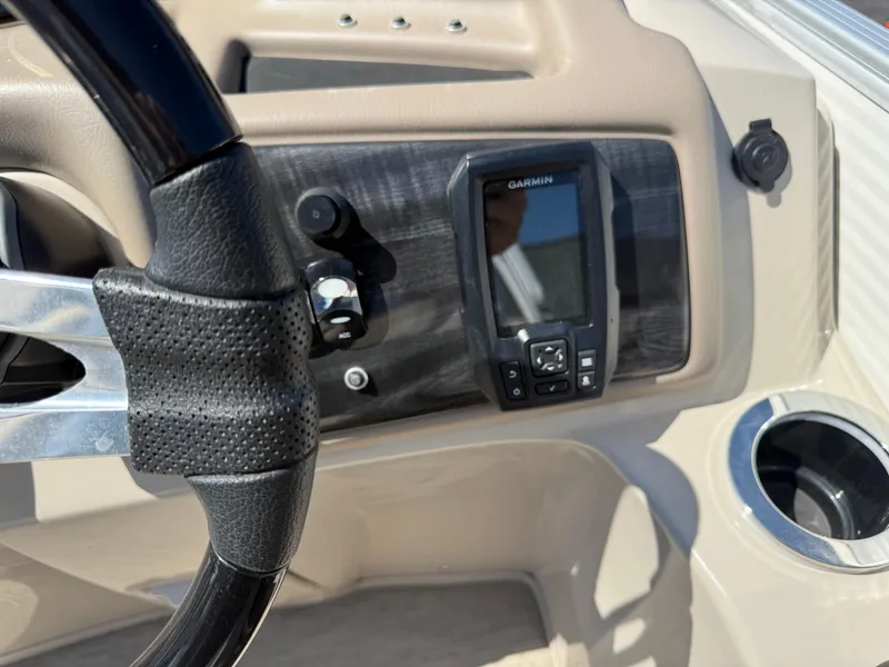 Slide: The Image of Steering wheel and Garmin device on 2017 Bennington G22 boat dashboard. - 12