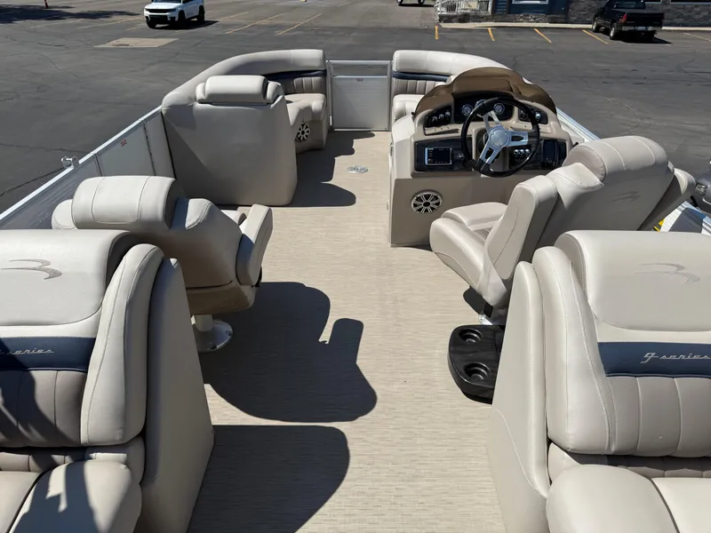 Slide: The Image of 2017 Bennington G22 pontoon boat interior with beige seating and steering console. - 17