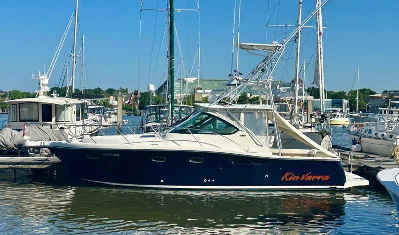 The Image of 2004 Tiara Yachts 3200 Open docked in a marina, surrounded by other boats. - 0