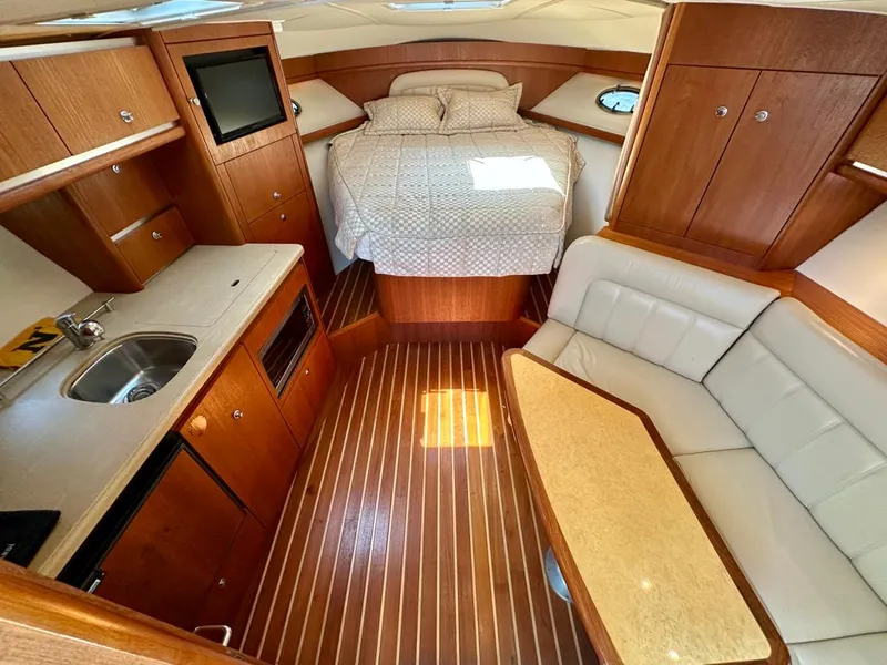 Slide: The Image of 2004 Tiara Yachts 3200 Open interior with bed, kitchenette, and seating area. - 17