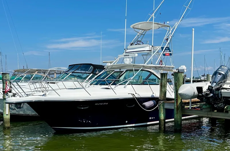 Slide: The Image of 2004 Tiara Yachts 3200 Open docked at marina under clear blue sky. - 2
