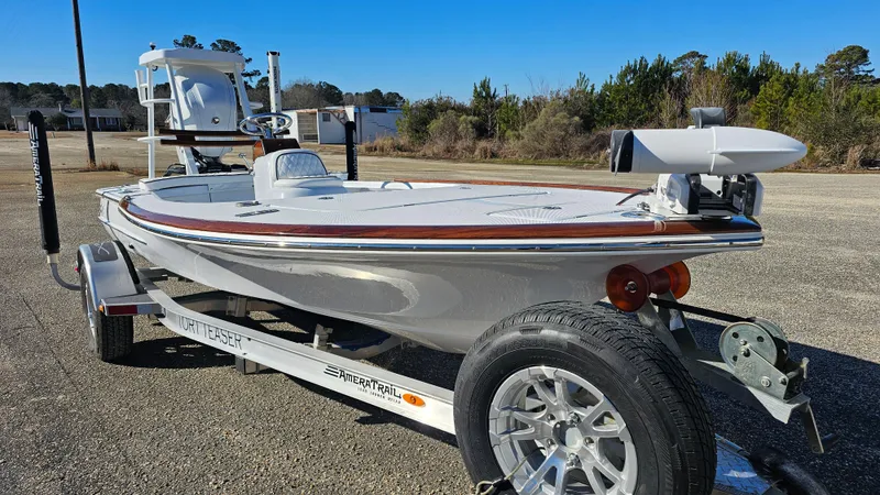 Slide: The Image of 2025 Chaos 16 Bonefish boat on trailer, parked outdoors, clear sky background. - 4