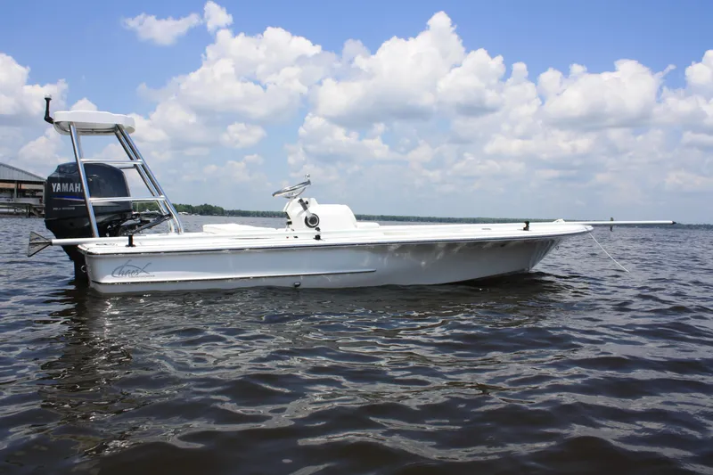Slide: The Image of 2025 Chaos 16 Bonefish boat on water under a cloudy sky. - 5