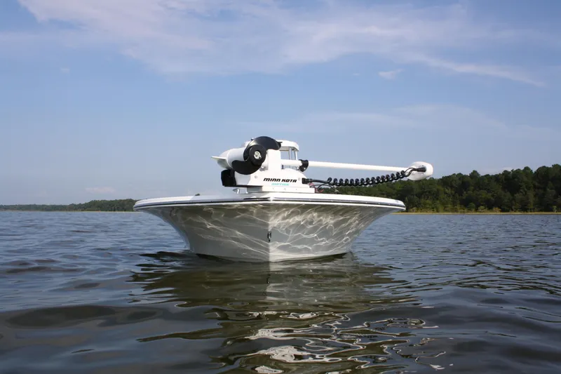 Slide: The Image of 2025 Chaos 16 Bonefish boat on calm water under a clear sky. - 7