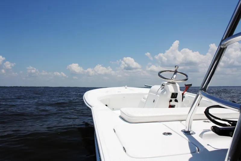 Slide: The Image of 2025 Chaos 16 Bonefish boat on open water under a clear blue sky. - 8