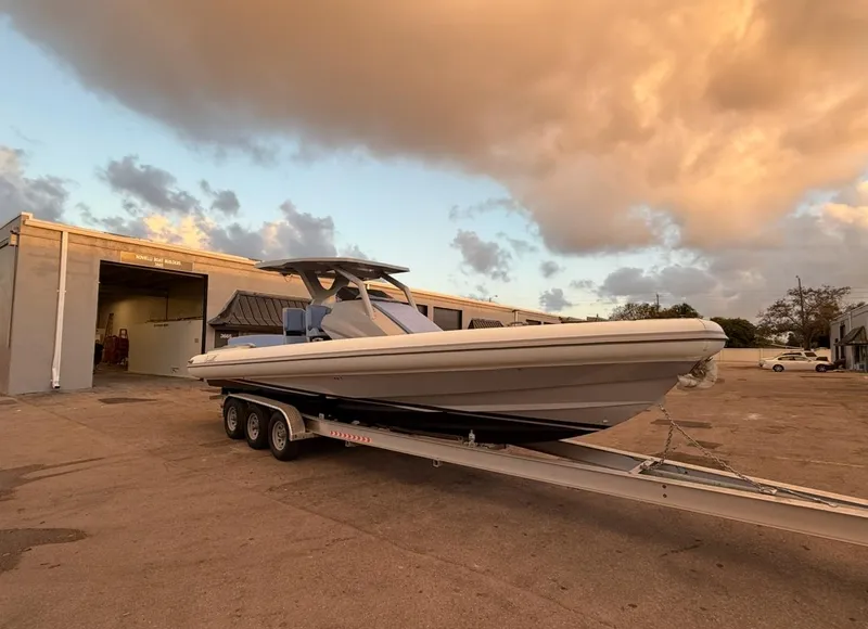 Slide: The Image of 2026 Novielli Veloche 349 boat on trailer at sunset near a workshop. - 11