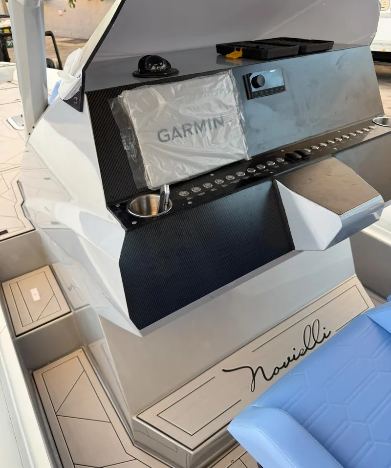 Slide: The Image of Novielli Veloche 349 boat dashboard with Garmin system, 2026 model, featuring modern controls. - 4