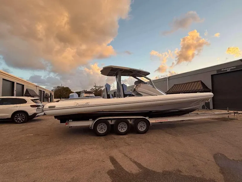 Slide: The Image of 2026 Novielli Veloche 349 boat on trailer, parked outdoors under a cloudy sky. - 8