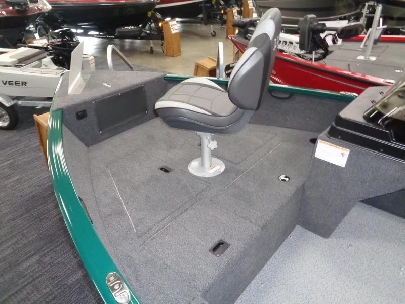 Slide: The Image of 2025 Lund 1650 Rebel XL SS boat interior with gray seating and carpeted deck. - 13